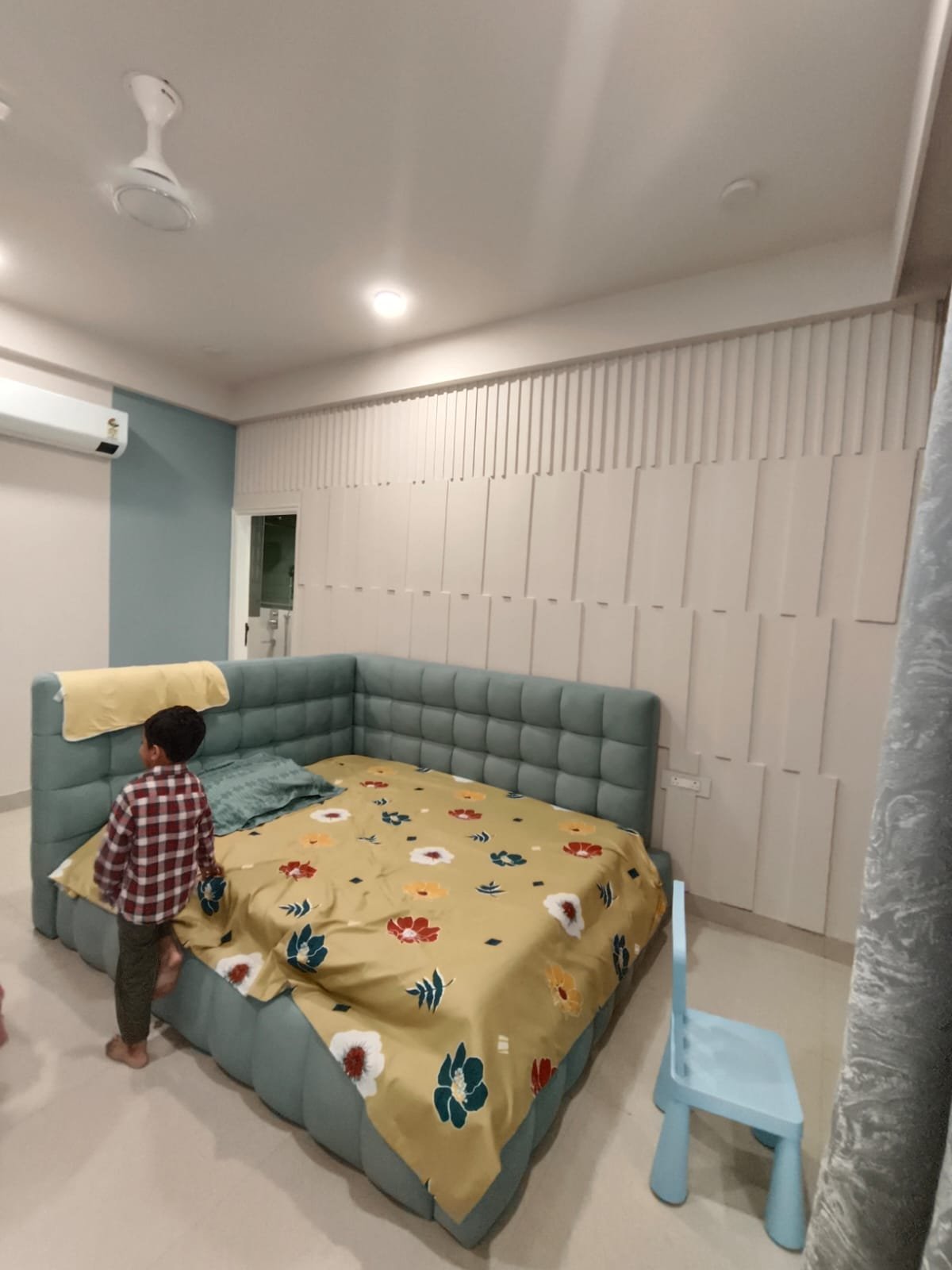 Kids room with corner bed and fluted panels