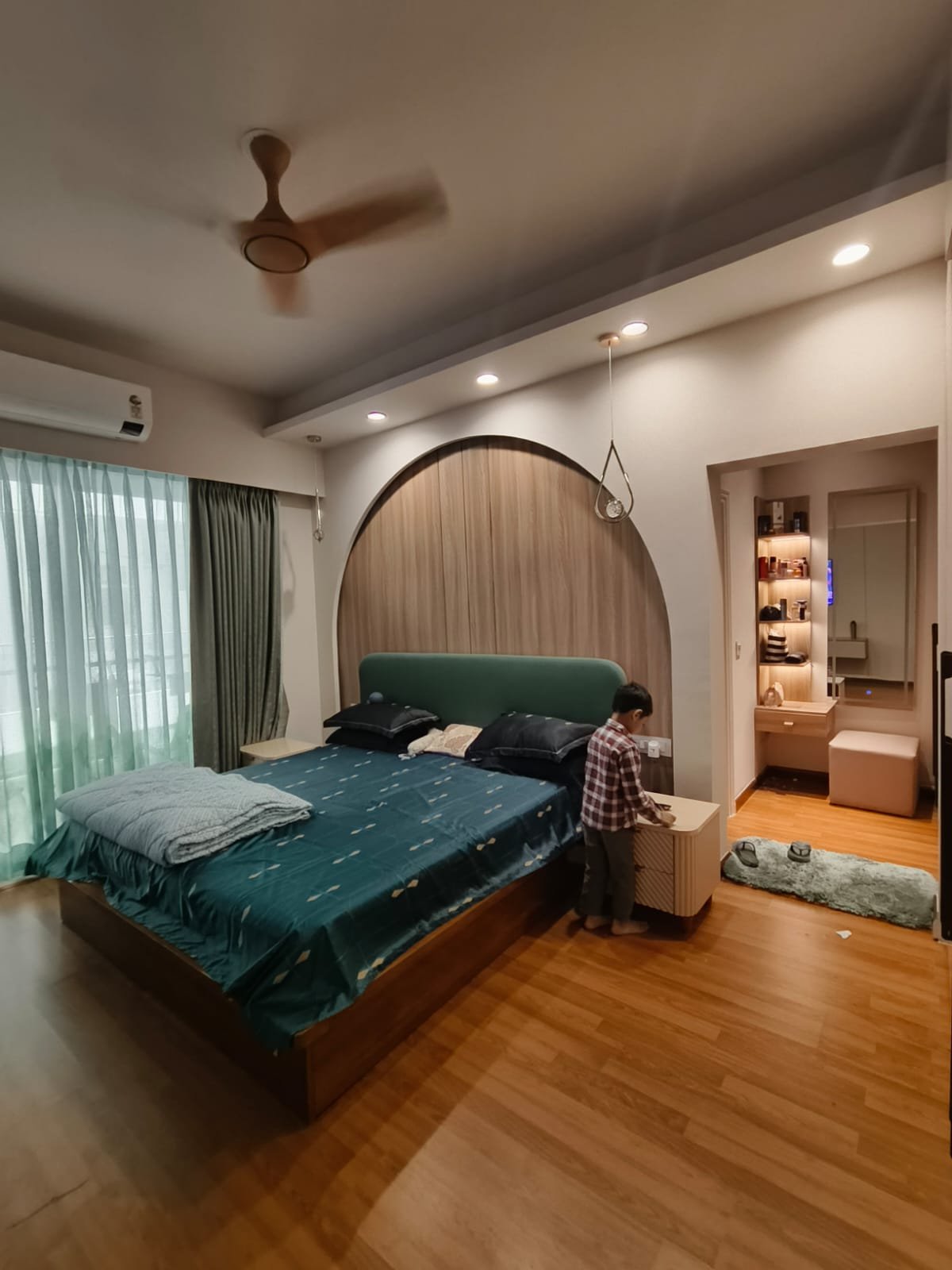 Master bedroom with arched headboard wall